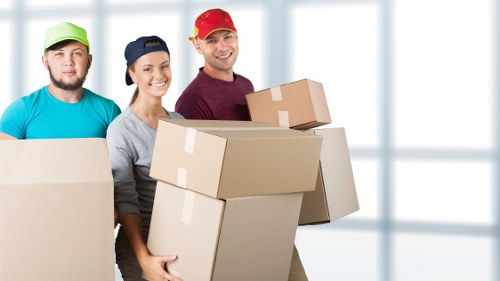 Moving boxes and household items in a Brixton flat with stair access