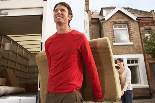 Local movers handling furniture from a Brixton student property