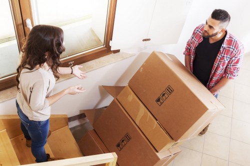 Local piano movers navigating a Brixton property staircase