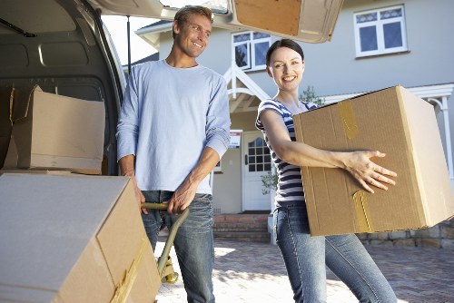 Removal team carrying items through a Brixton flat staircase